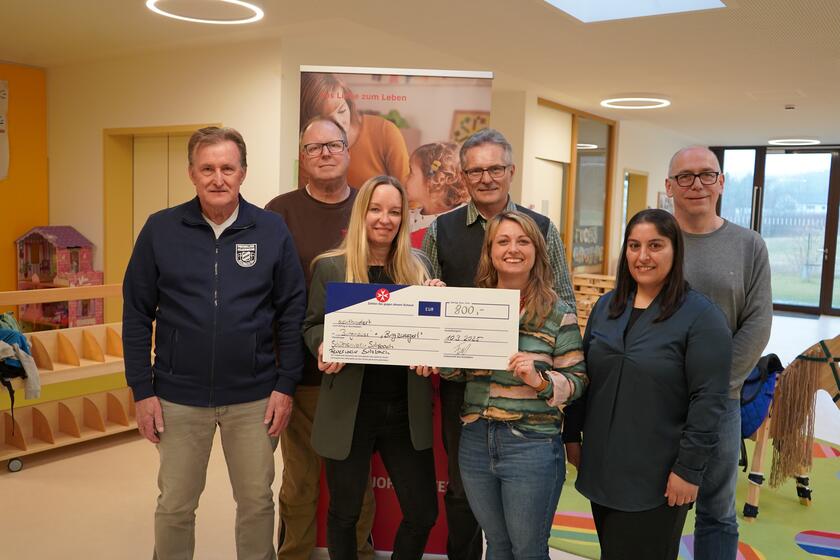 Freudige Präsentation des Spendenchecks 