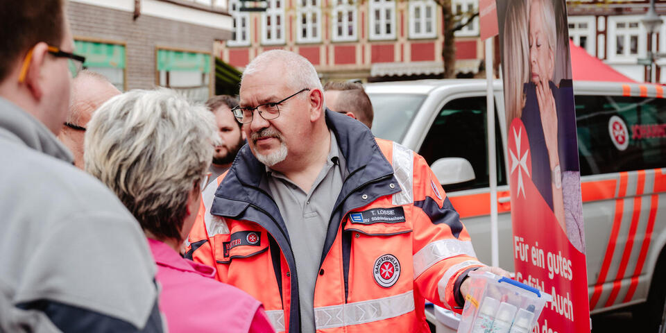 Ein Johanniter spricht mit Besuchern