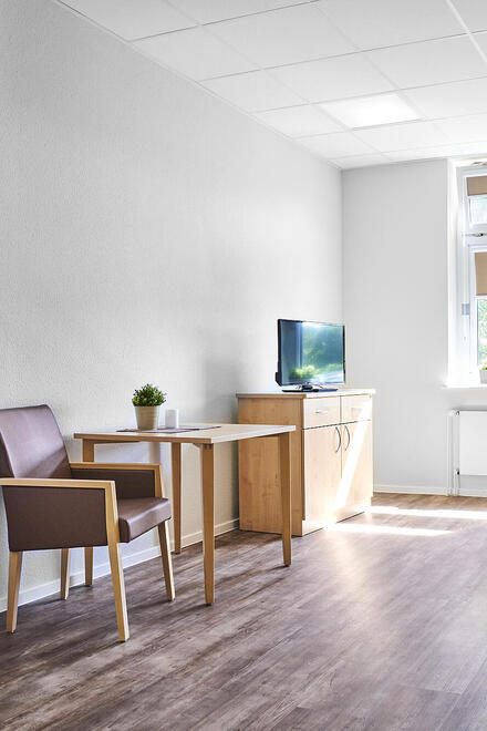 Man sieht einen Raum mit Tischen und Stühlen