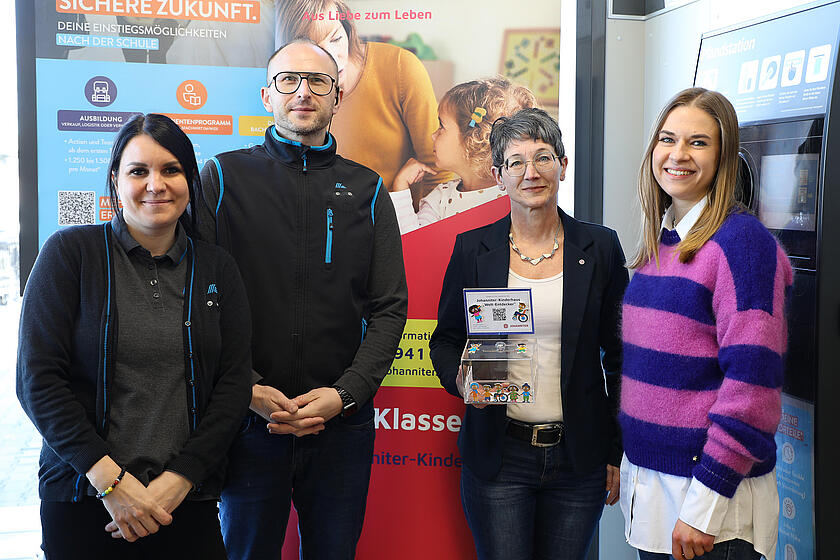 Einrichtungsleitung Susanne Pritzl übergibt die Pfandbon-Spendenbox an Anna Käsbauer (stellv. Filialleitung), Patrick Gryc (Filialleitung), Susanne Pritzl (Kinderhausleitung), Sarah Schilly (Regionalverkaufsleitung)