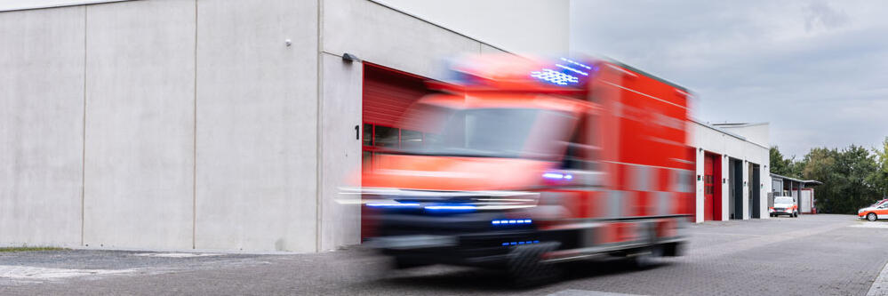 Ein Rettungswagen fährt mit Blaulicht aus der Rettungswache der Johanniter in Bad Nauheim heraus.