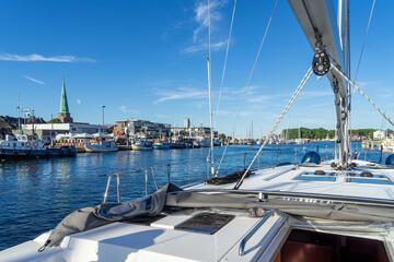 Im Vordergrund ist das Deck, im Hintergrund der Yachthafen und die Kirche von Travemünde zu sehen.