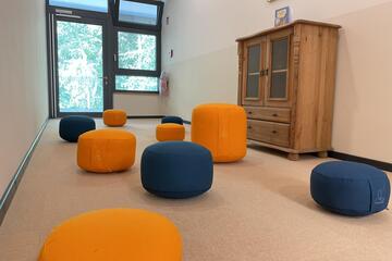 Ein gemütlicher Raum gefüllt mit Sitzpolstern.