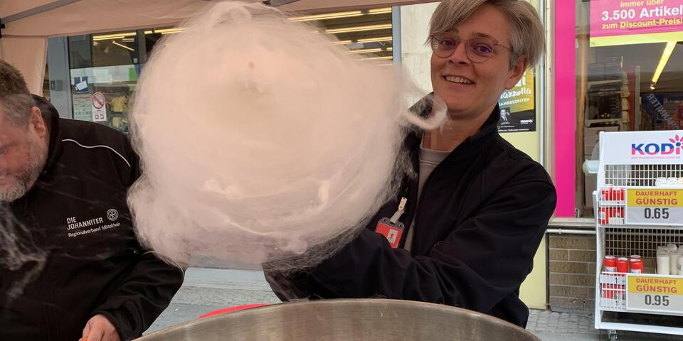Eine Mitarbeiterin macht eine große Zuckerwatte beim Schängelmarkt 2022