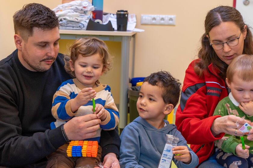 Stefan Scheewe, sozialpädagogischer Assistent, und Annika Siemßen, Kita-Leiterin, packen mit den Krippenkindern der Johanniter-Kita Rellingen die neuen Zahnbürsten aus.