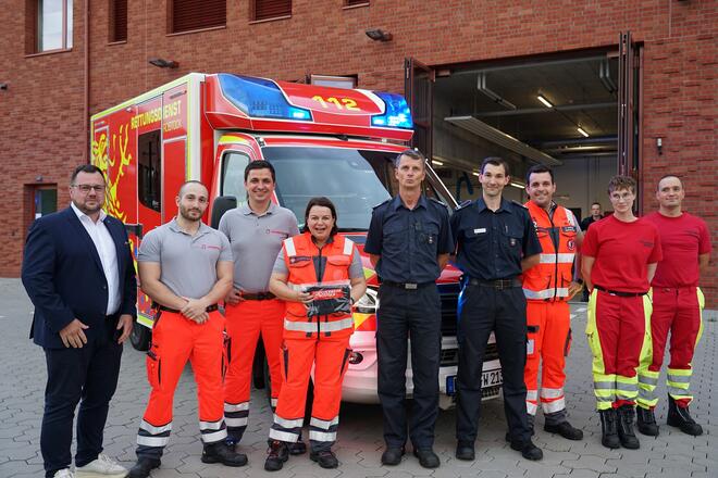 Ein Gruppenbild vor einem Einsatzfahrzeug mit Ministerin Drese und dem Team