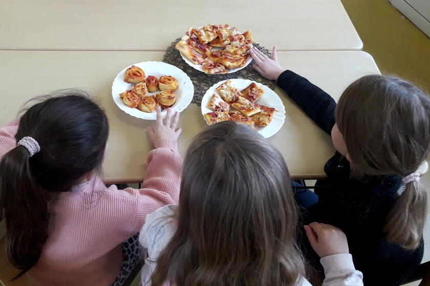 Kinder in der Mittagsbetreuung essen Pizza