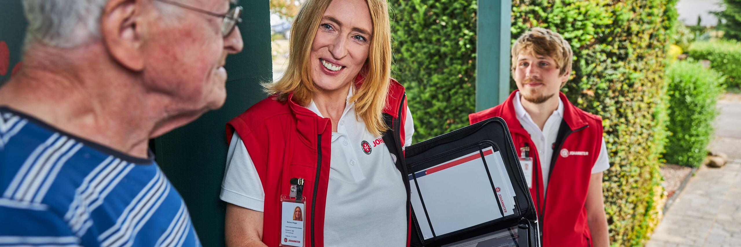 Johanniter-Botschafter im Gespräch mit einem Herren, beim Versuch Fördermitglieder zu gewinnen