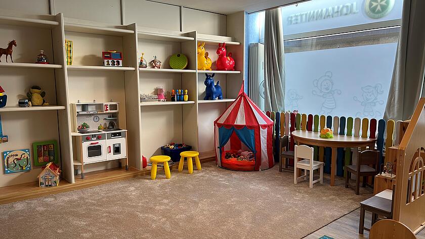 Der Hauptraum der Johanniter Kindertagespflege mit einem hellen Teppich und vielen Spielsachen