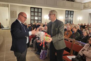 Der Moderator Volkmar Kuhn bedankt sich bei einem Referenten